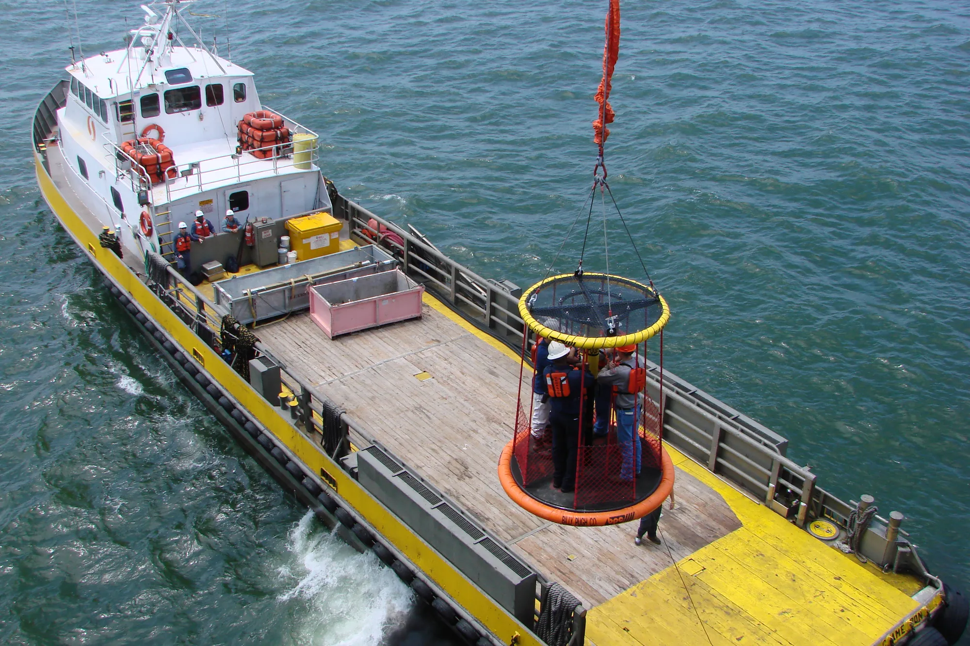 X-904 lifting personnel from the deck of a crew boat at sea