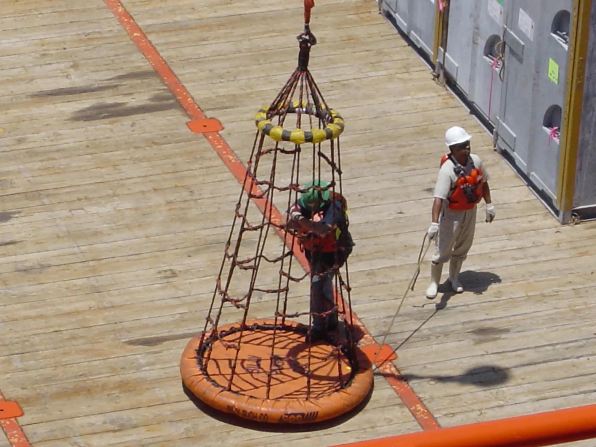 X-800 personnel transfer net lifting a rider on a vessel deck