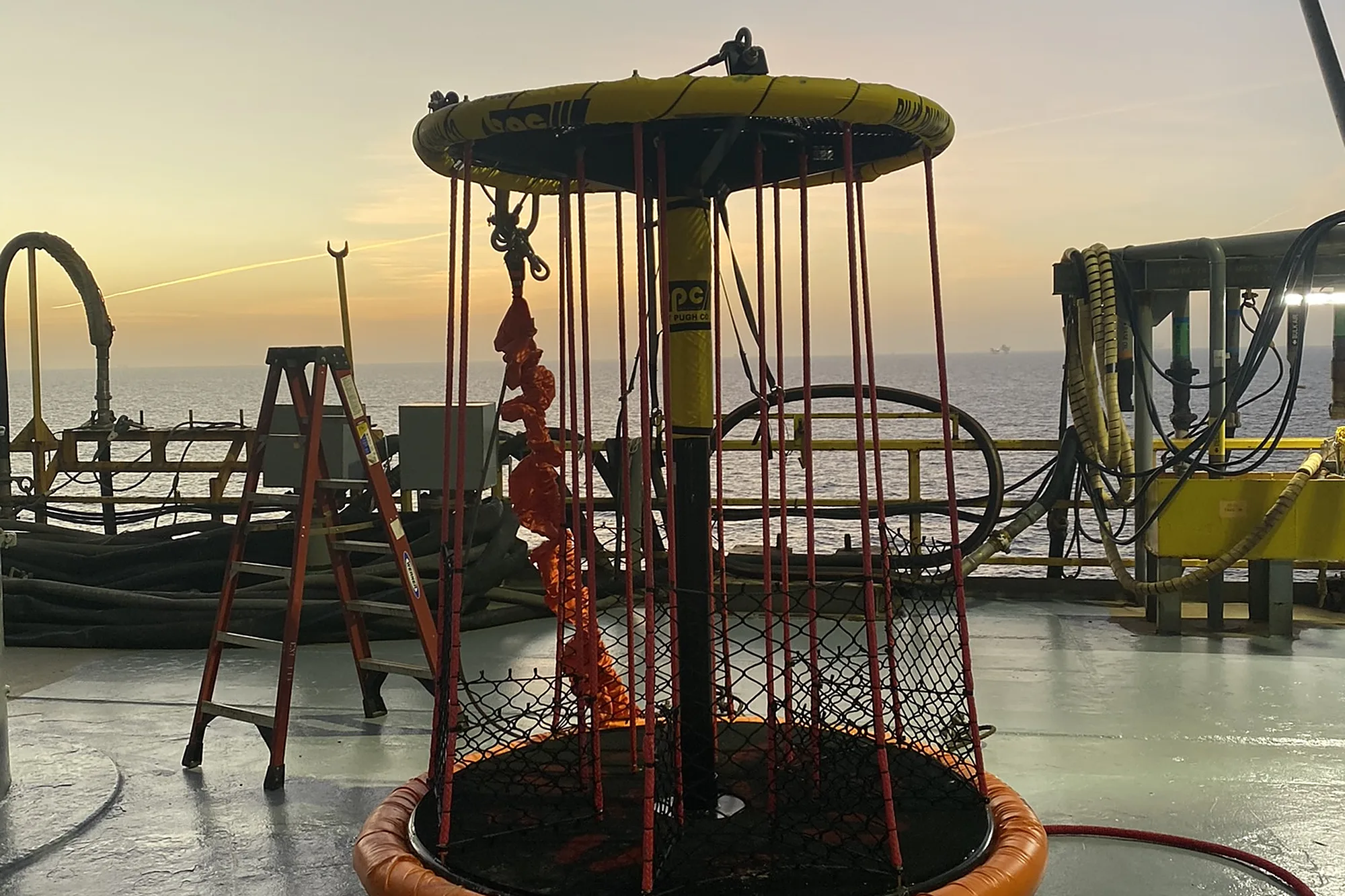 X-904 personnel transfer device on a rig deck at dusk