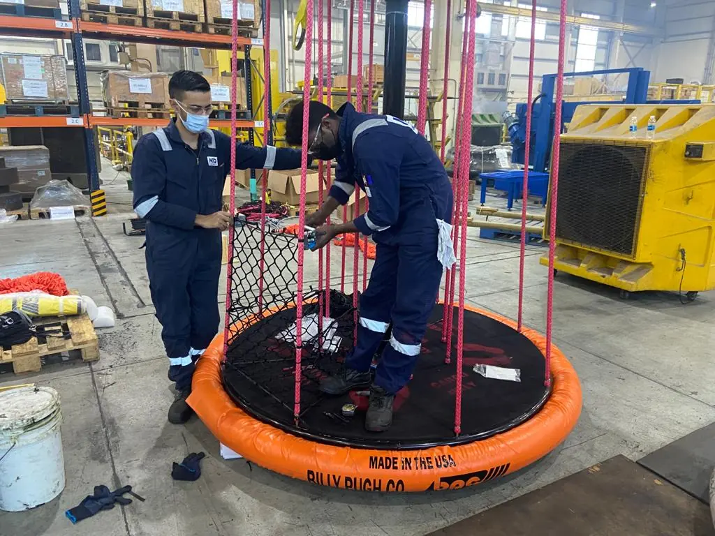 Technicians fitting side ropes to an X-904 during hands-on training